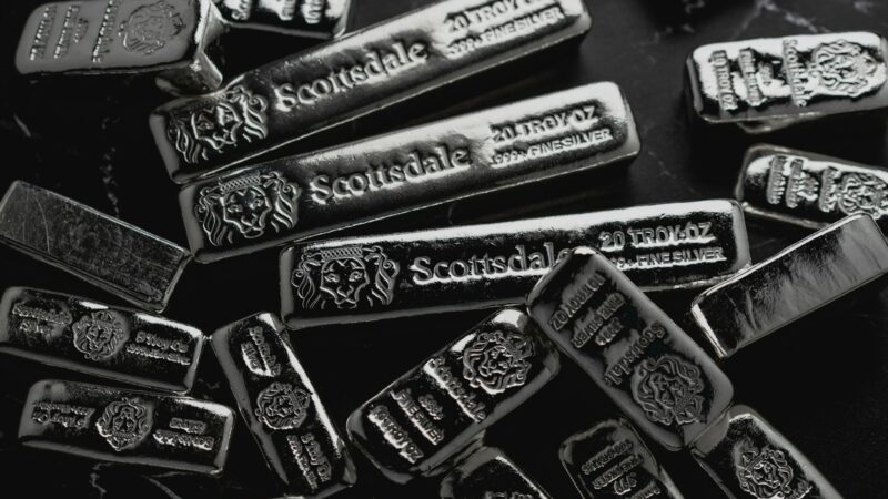 a pile of silver bars sitting on top of a table